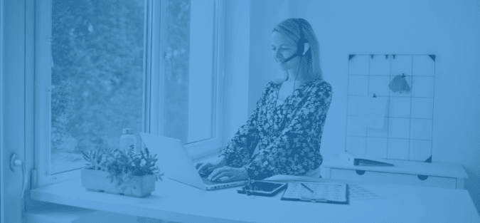 Lady who is standing correctly at home desk after receiving Occupational Health for remote workers